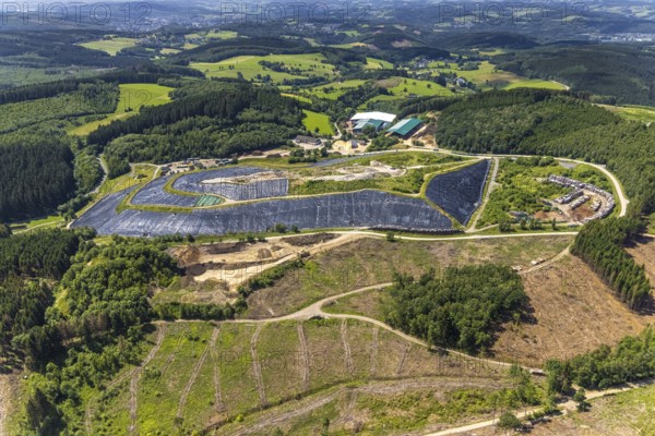 Aerial view, forest area with forest damage and clear cutting, area covered with plastic tarpaulins