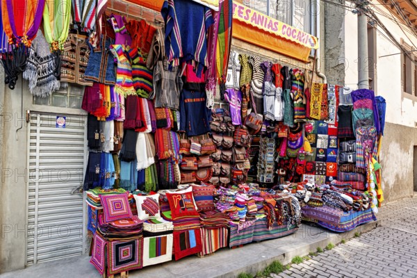 A market stall with colourful, handmade textiles and artistically designed fabrics at a lively