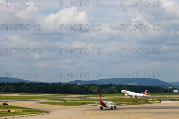 Swiss Airlines Passenger Airplane Take Off From the Runway and Flying Against Blue Sky and Clouds