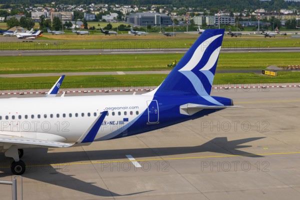 Aegean Airlines Passenger Airplane Taxiing on Runway in a Sunny Summer Day From the Airport in