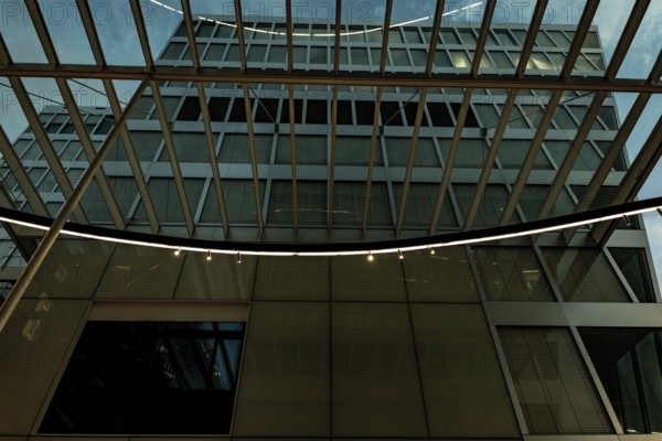 Modern Illuminated Office Building to Zurich Airport at Night in the Airport in Kloten, Zurich,
