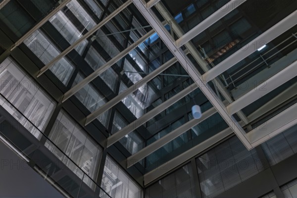 Modern Illuminated Office Building to Zurich Airport at Night in the Airport in Kloten, Zurich,