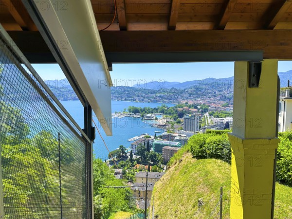 Panoramic View From Funicular Railway over Lake Lugano and Mountain View and Cityscape in a Sunny