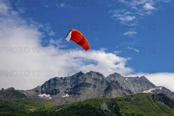 Kitesail and Mountain Peak in the Swiss Alps on Alpine Lake Silvaplana in a Sunny Summer Day in