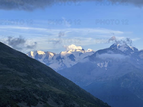 Beautiful Aerial View over the Swiss Alps with Glacier in a Sunny Summer Day and Sky with Clouds