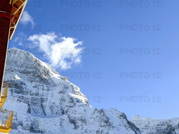 Hotel and Snowcapped Mountain Peak Mönch at 4107 Meter High in the Swiss Alps in a Sunny Winter Day