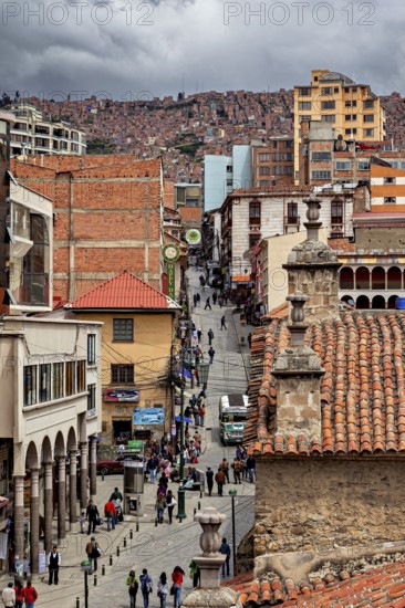 Lively city scene with tiled roofs and people on a street promenade, people in the streets of La