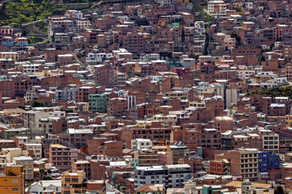 Dense cluster of houses on hills in an urban environment, The houses and skyscrapers of the city