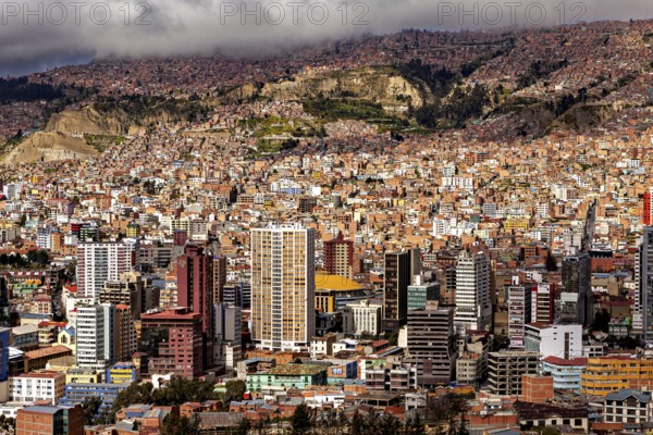 Dense cluster of houses of La Paz embedded in a hilly landscape, The houses and skyscrapers of the