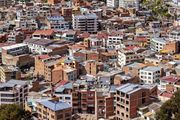 Dense cluster of houses with colourful roofs, The houses and skyscrapers of downtown La Paz in
