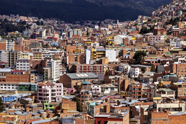 Dense urban development in front of a mountain landscape, The houses and skyscrapers of the city