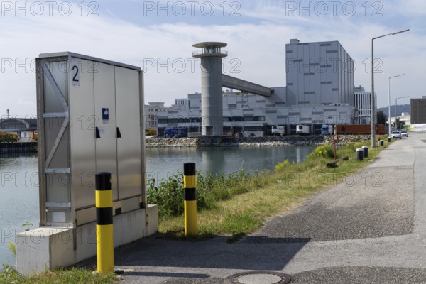 Industrial scenery with buildings next to a street under a blue sky, at the harbour Linz Upper