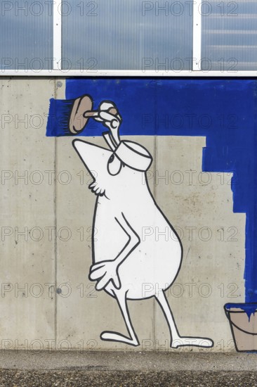 Cartoon painter painting an abstract blue surface on a concrete wall at the harbour of Linz Upper
