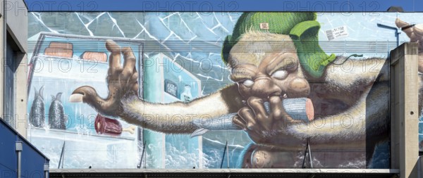 Caricature of a monster searching a fridge, as graffiti, at the harbour of Linz Upper Austria