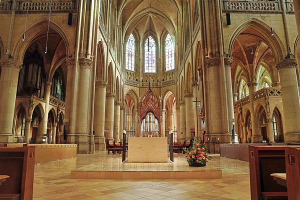 Magnificent interior of a Gothic church with high vaults and colourful stained glass windows, Maria