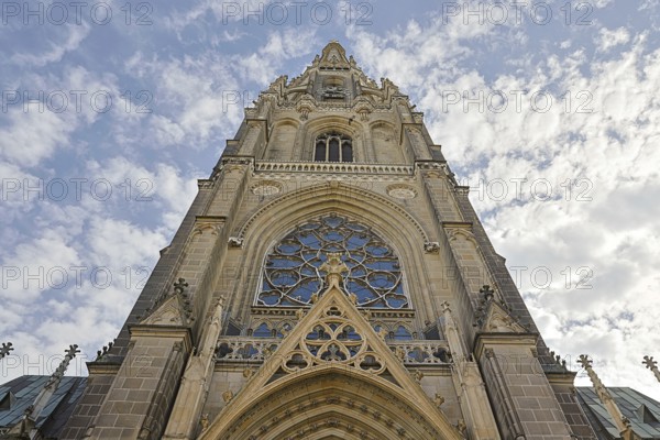 Detailed Gothic church façade rises dramatically into the cloudy sky, Maria Empfängnis Dom Linz