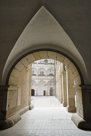 Arched passageway to an inner courtyard in a historic stone building, Arkardenhof Landhaus Linz