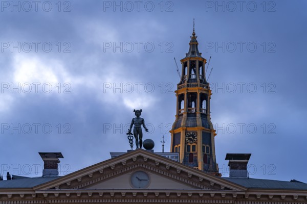 Statue of the god Mercury on the roof of the Korenbeurs former grain exchange and the steeple of