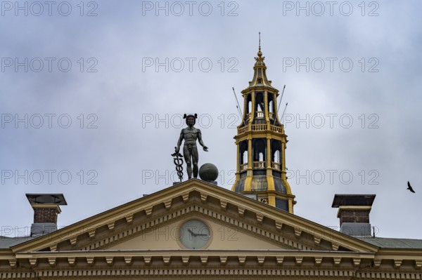 Statue of the god Mercury on the roof of the Korenbeurs former grain exchange and the steeple of
