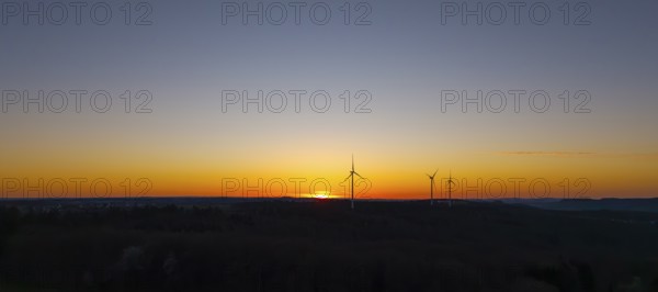 Silhouette of wind turbines at sunset in the distance, near Schorndorf im Remstal,
