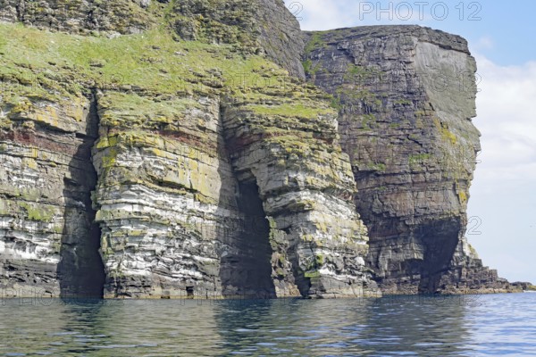 Dramatic cliffs with geological stratification over the sea, Isle of Noss, Shetland Islands,