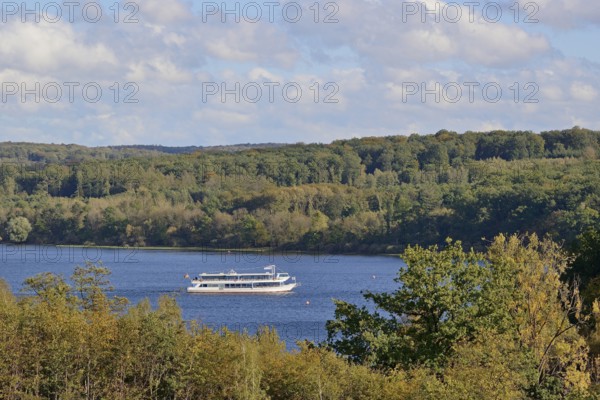 View of the Möhnesee with the passenger ship MS Möhnesee, autumn atmosphere, blue cloudy sky,