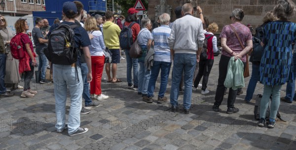 Interested tourists listen to a music group in the pedestrian zone, Nuremberg, Middle Franconia,