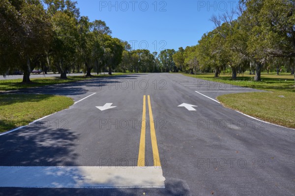 An empty car park with lane markings surrounded by trees, Flamingo, Everglades National Park,
