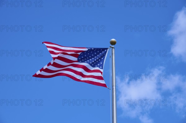 American flag fluttering against a clear blue sky on a sunny day, Flamingo, Everglades National