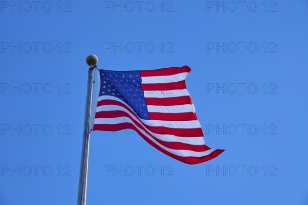 American flag flies majestically in front of a slightly cloudy sky, Flamingo, Everglades National