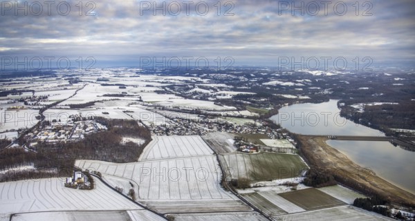 Aerial view of Möhnesee in winter with snow and view of Körbecke in Möhnesee in Sauerland in North