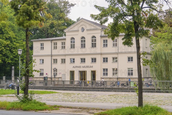 Front view of the Alpine Museum, framed by trees. A classic building in an urban environment,