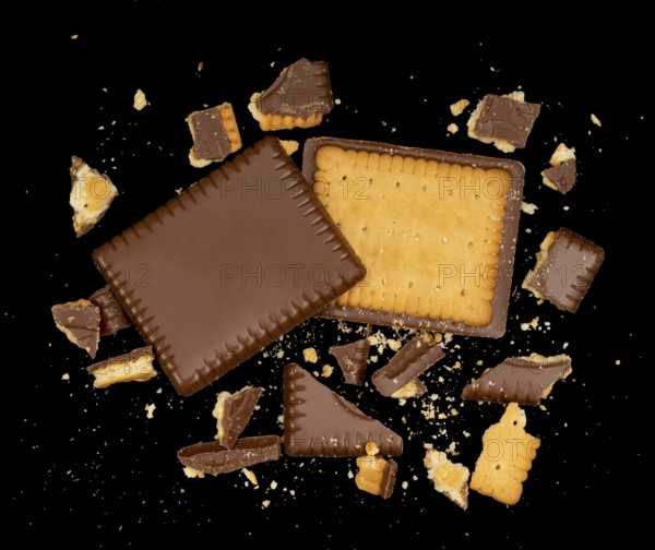 Butter biscuit cakes with chocolate and lots of broken pieces around in black back