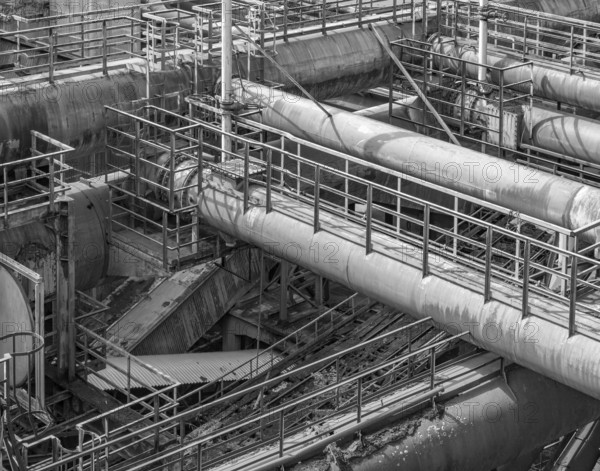 Black and white weathered rusty high angle industrial scenery with old corroded steel girders and