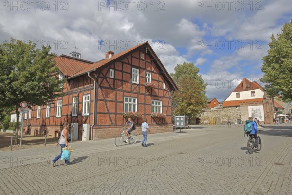 Volksbank building, half-timbered house, historic Hague Gate, pedestrians, cyclists, Haldensleben,