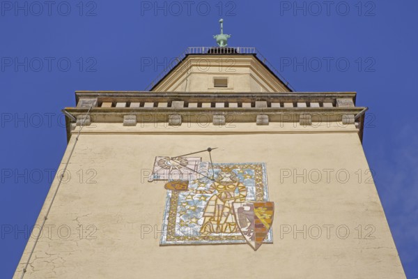 Tower with town coat of arms and sundial, wall mosaic, figure with shield and crown, view upwards,
