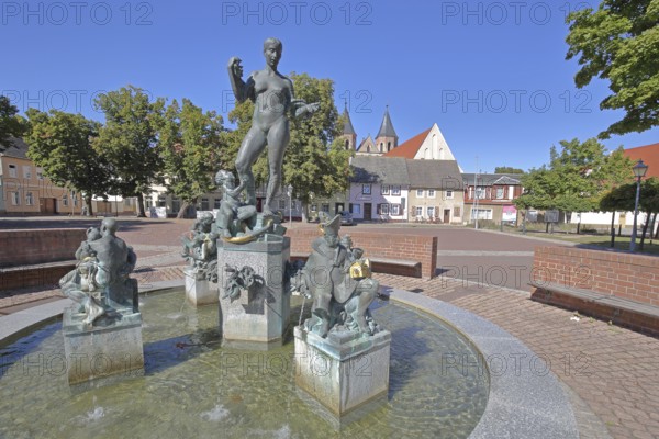 Market fountain by Frank Sobirey on the history of the town, nude female figure and putti, modern