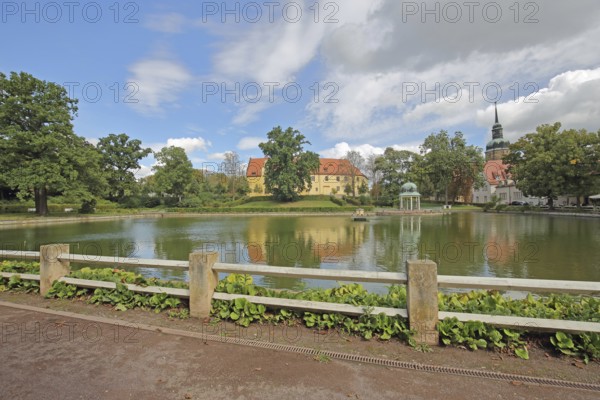 Castle and pavilion at the spa park pond with church tower of the town church, Goethe School,