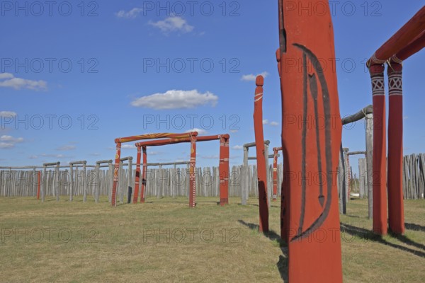 Archaeological reconstructed circular ditch from the Stone Age, Bronze Age, poles with runes, bow