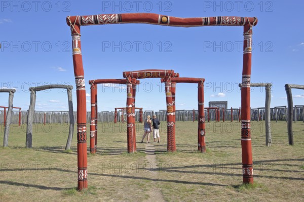 Archaeological reconstructed circular ditch from the Stone Age, Bronze Age, archway with visitors,
