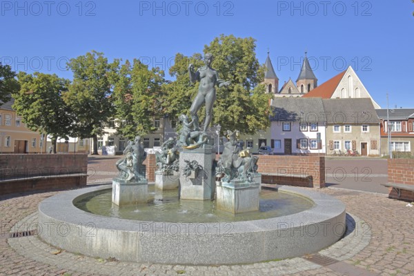 Market fountain by Frank Sobirey on the history of the town, nude female figure and putti, modern