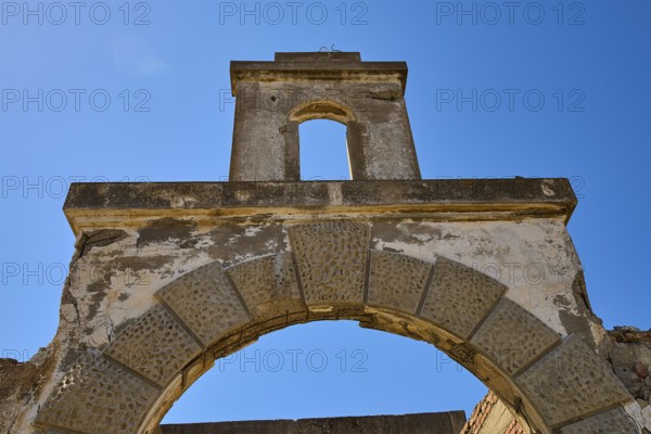 Abandoned stone archway under a clear blue sky, showing signs of weathering, Old Silk Factory,