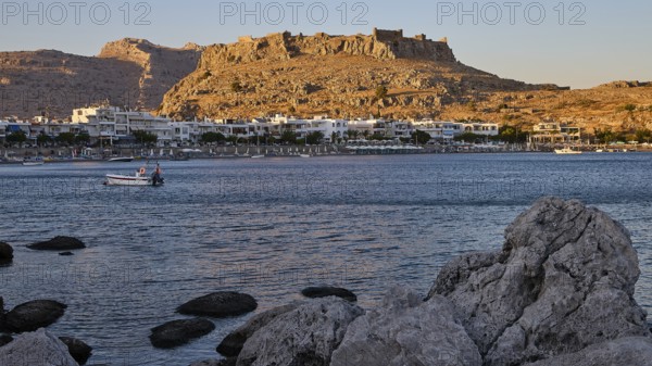 Feraklos fortress, coastal town with a castle above the evening sky and rocks on the shore, bay,