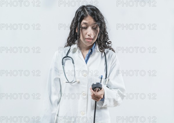 Surprised doctor with blood pressure monitor. Surprised female doctor with blood pressure monitor