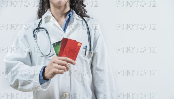 Doctor holding credit cards isolated. Unrecognizable doctor with credit cards, medical payment