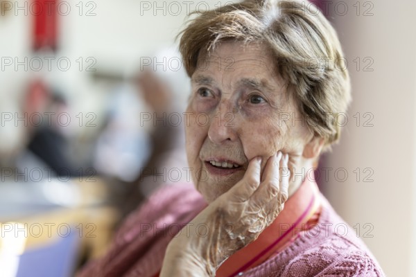 Close-up, authentic, unposed portrait of a 90+ year old senior woman with dementia and Alzheimer's