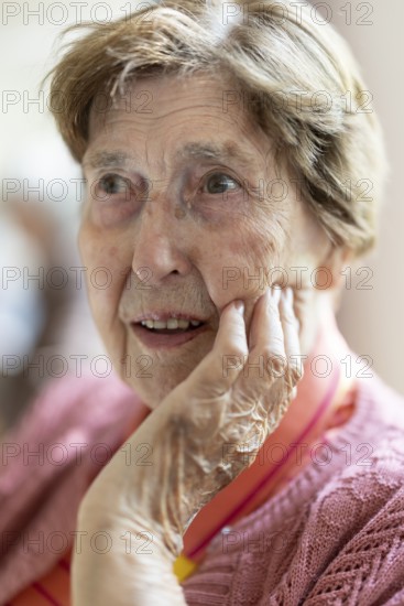 Close-up, authentic, unposed portrait of a 90+ year old senior woman with dementia and Alzheimer's