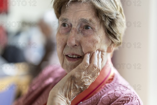 Close-up, authentic, unposed portrait of a 90+ year old senior woman with dementia and Alzheimer's