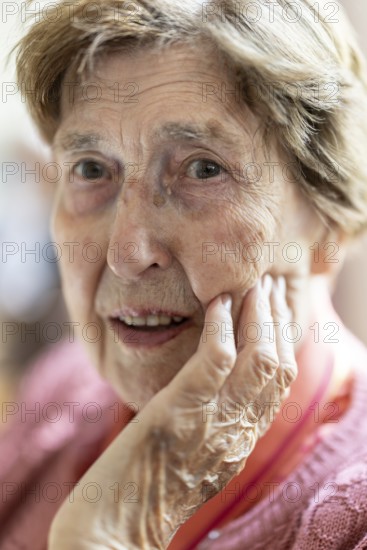 Close-up, authentic, unposed portrait of a 90+ year old senior woman with dementia and Alzheimer's