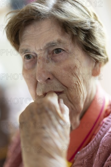Close-up, authentic, unposed portrait of a 90+ year old senior woman with dementia and Alzheimer's